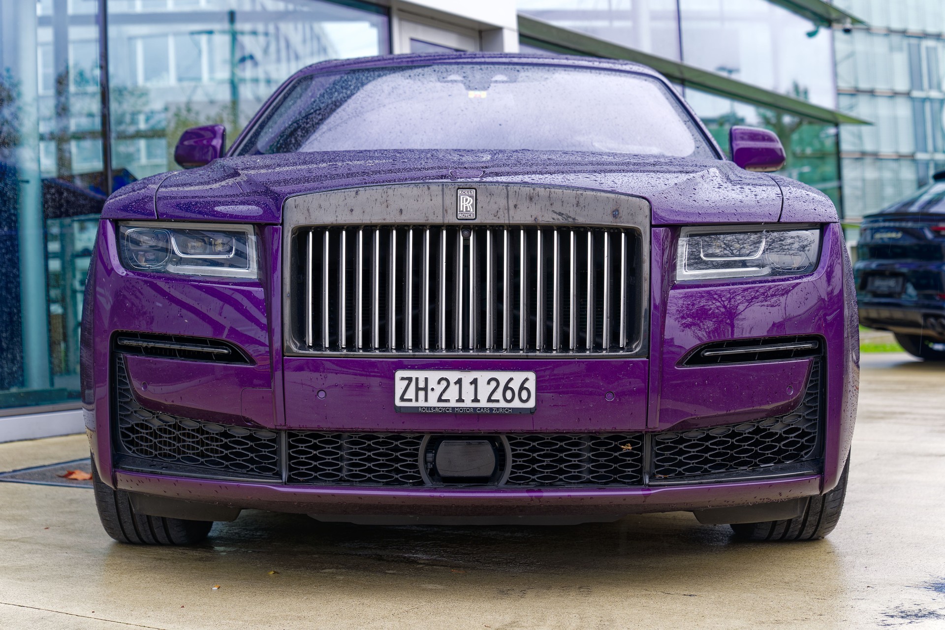 Scenic view of expensive elegant car outside of car dealership at Swiss town.